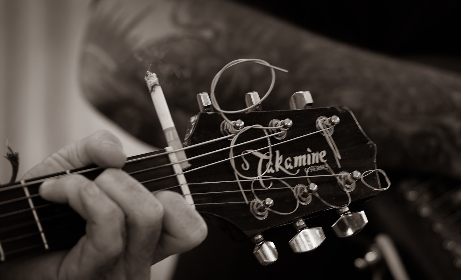 Hand measuring string action at the twelfth fret with a ruler